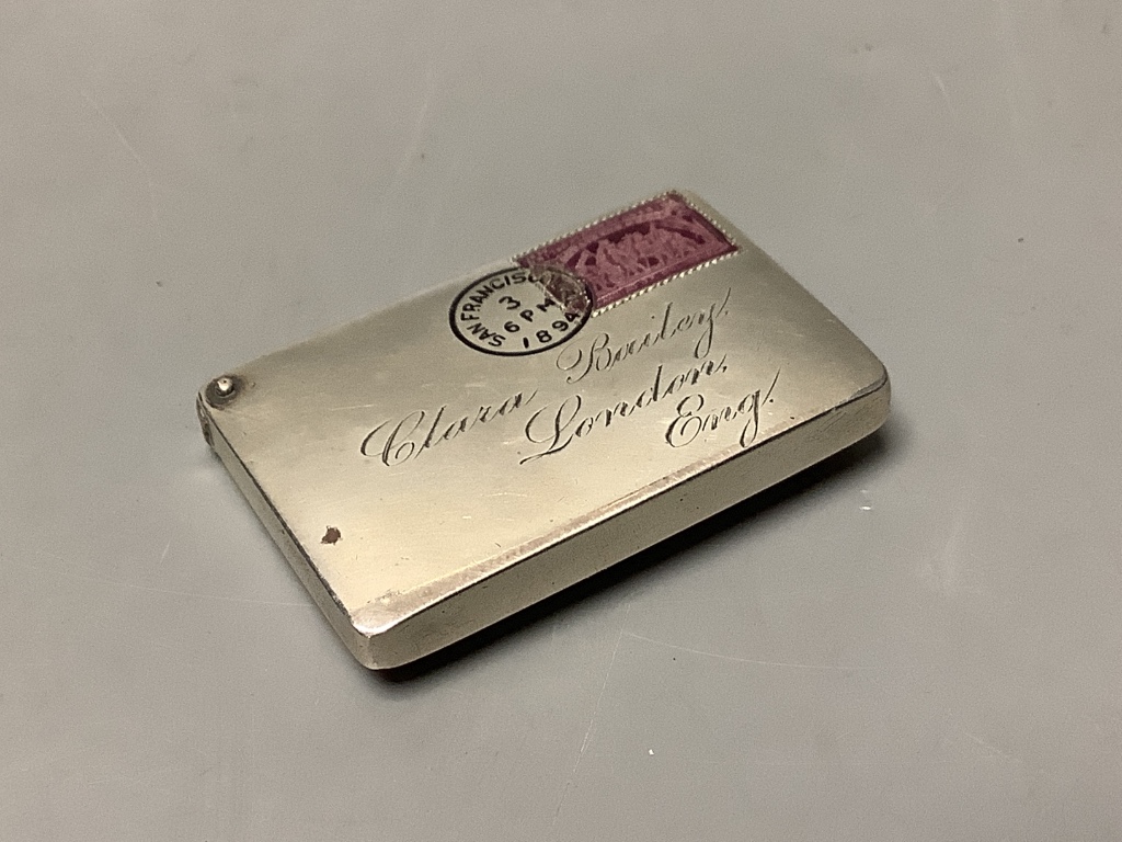 A late 19th century American? sterling and enamel novelty stamp case, modelled as an envelope, addressed to 'Clara Bailey, London, Eng.', 42mm